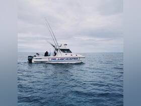 The 'Pelagic Hunter' fishing boat is seen cruising through calm waters, showcasing its fishing gear and readiness for an adventure on the open sea.