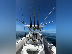A well-equipped fishing boat featuring multiple fishing rods and reels, perfect for a day of deep-sea fishing adventures.