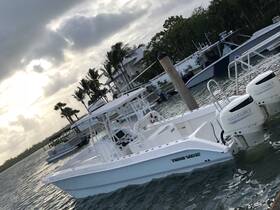 A sleek Twin Vee speedboat docked in calm waters, showcasing its modern design and powerful Suzuki engines — perfect for thrilling adventures on the water.