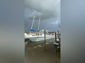 A sleek speedboat docked at the marina, showcasing its design against a dramatic sky — perfect for water adventures.
