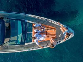 A group of friends enjoys a sunny day on a boat, relaxing and soaking up the sun — perfect for a fun day out on the water.