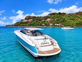 A stunning yacht named 'Solara' anchored in crystal-clear waters, surrounded by lush greenery and picturesque hills — perfect for luxury getaways and scenic cruises.