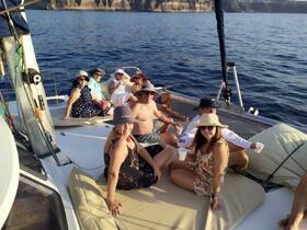 A lively group enjoys a fun day aboard a catamaran, relaxing and celebrating with drinks under the sun — perfect for memorable outings on the water.