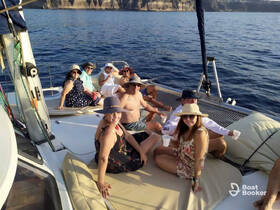 A lively group enjoys a fun day on a catamaran, relaxing and celebrating with drinks under the sun — perfect for memorable outings on the water.