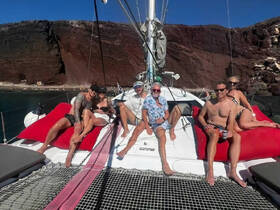 A lively group enjoys a day on a catamaran, relaxing on deck and soaking up the sun — perfect for memorable outings and celebrations on the water.