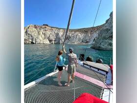 A couple enjoys the stunning coastal scenery from the deck of a boat, creating a perfect backdrop for memorable moments on the water.
