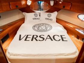 Luxurious cabin interior featuring a Versace-themed bed, perfect for upscale boating experiences.