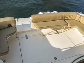 Interior view of a boat's seating area, featuring comfortable cushions and a clean layout, perfect for relaxing while on the water.