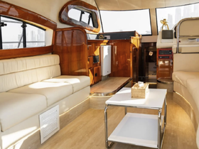 Interior view of a stylish boat cabin featuring comfortable seating and modern amenities, perfect for relaxing while cruising.