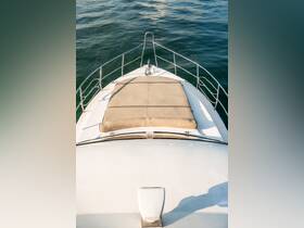 Aerial view of the front deck of a yacht featuring a spacious sun pad, perfect for relaxing on the water.