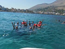 A lively group of swimmers enjoys a sunny day in the clear waters, showcasing the fun and excitement of a perfect day on the water.