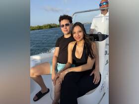 A couple enjoys a sunny boat ride, capturing the essence of a perfect day on the water.