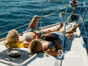 Two friends relax and sunbathe on the deck of a yacht, enjoying the serene ocean views — a perfect moment for leisure and bonding on the water.