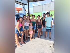A cheerful group of family and friends gathers at a fuel station, ready for their boating adventure — perfect for creating lasting memories on the water.