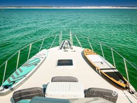 A serene view of paddleboards resting on the deck of a boat, surrounded by vibrant green waters — perfect for a day of water sports and relaxation.