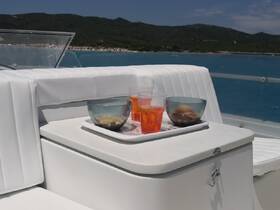 A stylish setup of cocktails and snacks on a boat, perfect for enjoying a relaxing day on the water with friends or family.