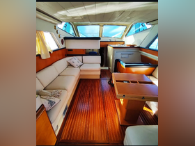 A cozy interior view of a boat cabin featuring comfortable seating and a well-designed layout, perfect for relaxing while on the water.