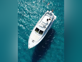 An aerial view of a boat with guests swimming in the clear turquoise waters, showcasing a perfect day on the water.