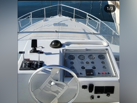 A detailed view of the helm and control console on a boat, showcasing the steering wheel and various gauges — perfect for navigating the open waters.