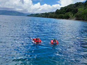 Two snorkelers explore the vibrant waters, showcasing the beauty of marine life in a tropical paradise — perfect for adventure seekers and ocean lovers.