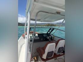 Interior view of a boat's helm showcasing the steering console and seating, perfect for navigating the beautiful waters.