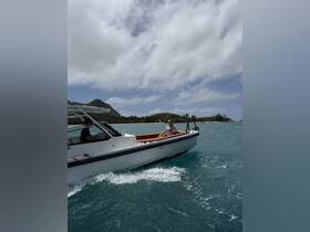 A woman relaxes on the deck of a boat while cruising through beautiful waters, showcasing the joy of a day on the ocean.