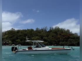 A sleek speedboat glides through turquoise waters, showcasing its elegant design against a backdrop of lush greenery — perfect for exploring coastal destinations.