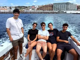 A group of friends enjoys a sunny day on a boat, capturing the essence of adventure and camaraderie on the open water.