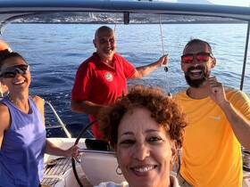 A joyful group of friends enjoys their time aboard a boat, capturing a moment of celebration and camaraderie on the water.