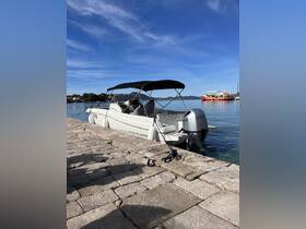 A sleek speedboat docked at a picturesque marina, showcasing its modern design against a clear blue sky.