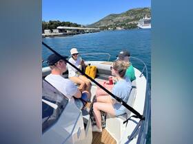 A group of friends enjoys a sunny day on a boat, creating memorable moments together on the water.