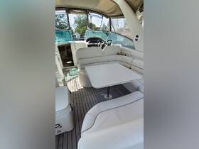 Interior view of a luxurious boat cabin featuring plush seating and a helm, perfect for comfortable cruising and relaxation on the water.