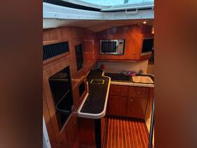 A well-equipped boat kitchen featuring modern appliances and elegant wood finishes, perfect for preparing meals while on the water.