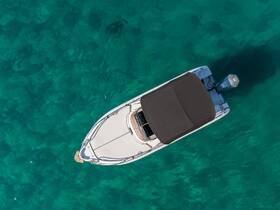Aerial view of a sleek boat cruising through crystal-clear waters, showcasing its elegant design and perfect for a day on the water.