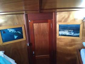 Interior view of a boat cabin featuring framed underwater photographs of marine life, showcasing the unique decor and ambiance of the space.