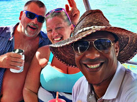 A joyful group of friends enjoying drinks and laughter on a boat, capturing the essence of a fun day on the water.