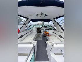 Interior view of a spacious boat cabin featuring comfortable seating and a well-equipped helm, perfect for relaxing and enjoying time on the water.