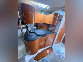 A well-designed interior of a boat's kitchen area featuring elegant cabinetry and modern amenities, perfect for onboard dining and relaxation.