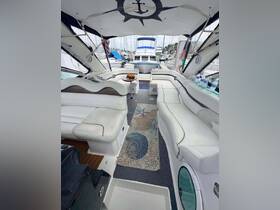 A spacious and elegantly designed interior of a boat featuring comfortable seating and a stylish decor, perfect for relaxing while enjoying the marina views.