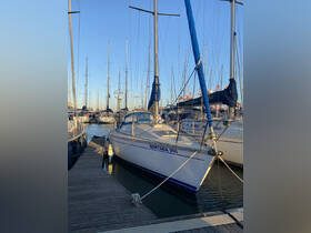 A beautiful yacht named 'Nortada VIII' docked at a marina, surrounded by other vessels under a clear blue sky.