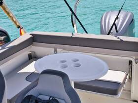 A well-appointed interior view of a boat's seating area, featuring a table and comfortable helm, perfect for relaxing while enjoying the water.