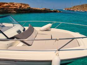 A stunning view of the front deck of a yacht, showcasing its sleek design against the vibrant turquoise waters, perfect for a day of relaxation on the sea.