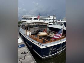 A classic yacht named 'Konstantin' docked in Jersey City, showcasing its elegant design and inviting seating area, perfect for leisurely outings.
