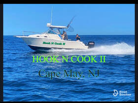 The 'Hook N Cook II' speeds through the waters off Cape May, NJ, showcasing a thrilling fishing adventure on the open sea.