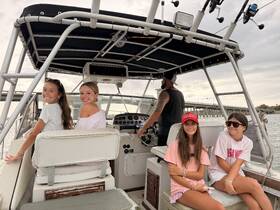 A group of friends enjoying a fun day on the boat, capturing the joy of boating adventures together.