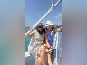 Two friends enjoy a sunny day on a boat, capturing the perfect moment for their adventure on the water.