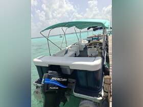 Interior view of a pontoon boat featuring comfortable seating and a helm, perfect for leisurely outings on the water.