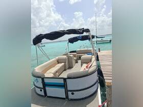 Interior view of a spacious pontoon boat featuring comfortable lounge seating, perfect for relaxing on the water.
