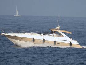 A sleek speedboat cuts through the water, showcasing its elegant design and performance. Ideal for thrilling day trips on the open sea.