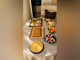 A beautifully arranged spread of appetizers and snacks on a boat table, perfect for entertaining guests during a day on the water.